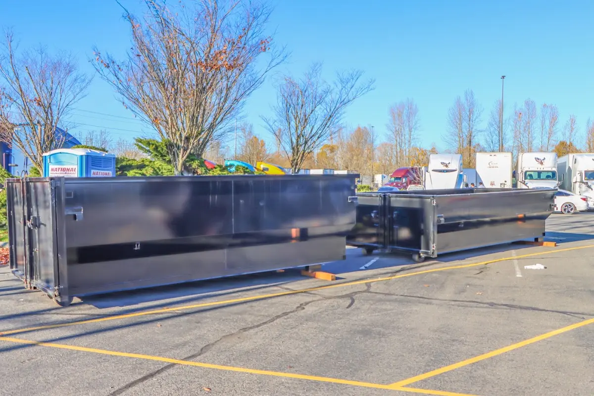 Professional dumpster rental service with roll-off container on residential driveway in Seekonk